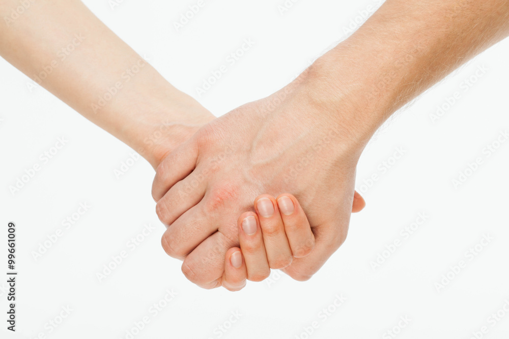 Man's hand gently holding woman's hand Man's hand gently holding woman's hand
