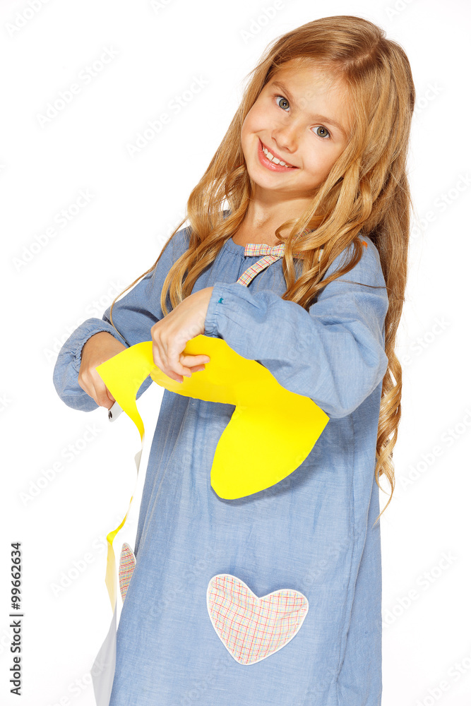 Cute little girl with scissors and yellow paper Cute little girl with scissors and yellow paper