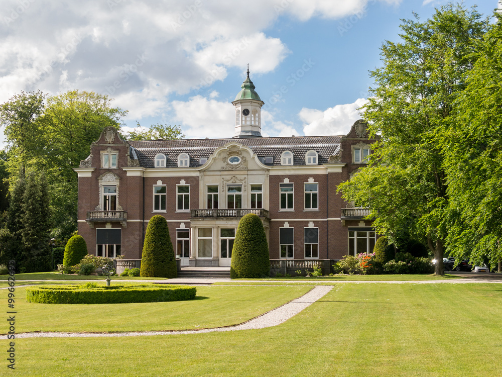 Manor estate Rusthoek surrounded by trees and lawn in Baarn, Netherlands