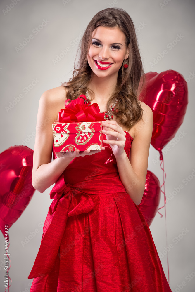 Beautiful smiling woman with a gift Beautiful smiling woman with a gift