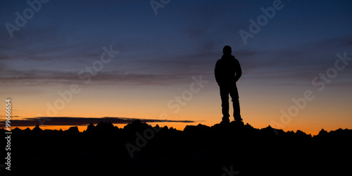 Hiker on top of mountains at sunrise