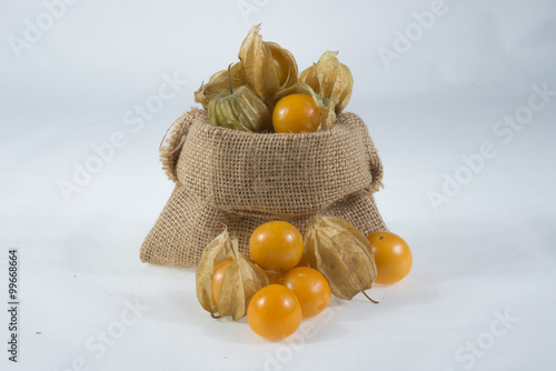 Isolated cape gooseberry in small sack on white background
