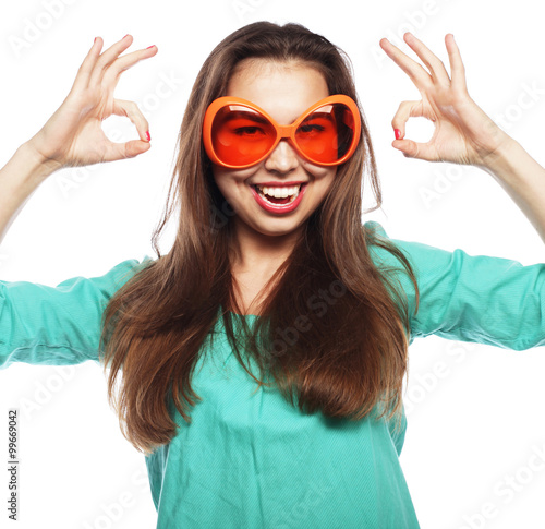  Playful young woman with party glasses. 