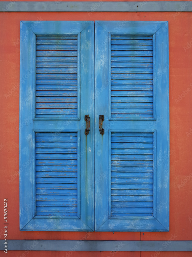 old blue window on red wall