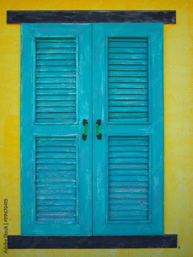 Old window on yellow wall Old window on yellow wall