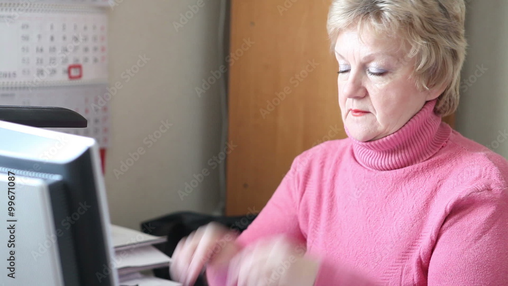 woman working at the computer and massages tired eyes woman working at the computer and massages tired eyes