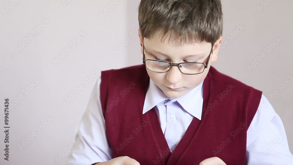 boy with glasses playing the tablet at school boy with glasses playing the tablet at school