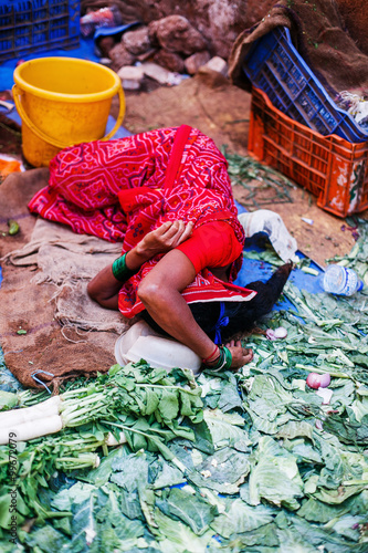 the market in India, a woman is sleeping © polinariaegorova