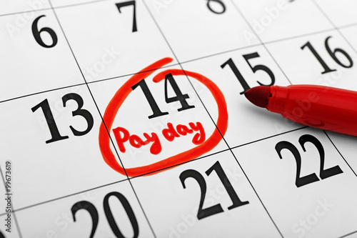 Payday concept. Calendar with red felt pen background. Date in frame, close up