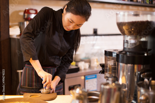 waitress serving in modern cafe