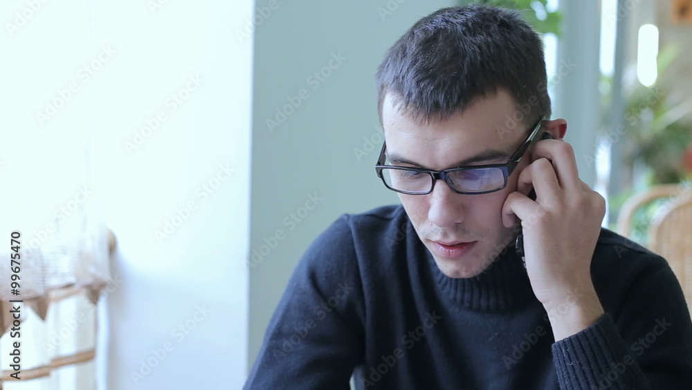 The guy with glasses talking on the phone The guy with glasses talking on the phone