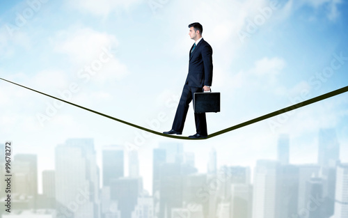 Salesman walking on rope above the city