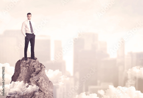 Confident businessman on dangerous cliff