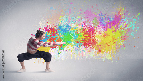 Young colorful street dancer with paint splash