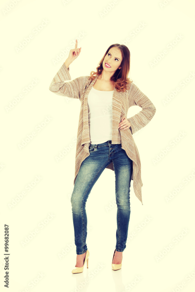 Happy smiling woman pointing up. Happy smiling woman pointing up.