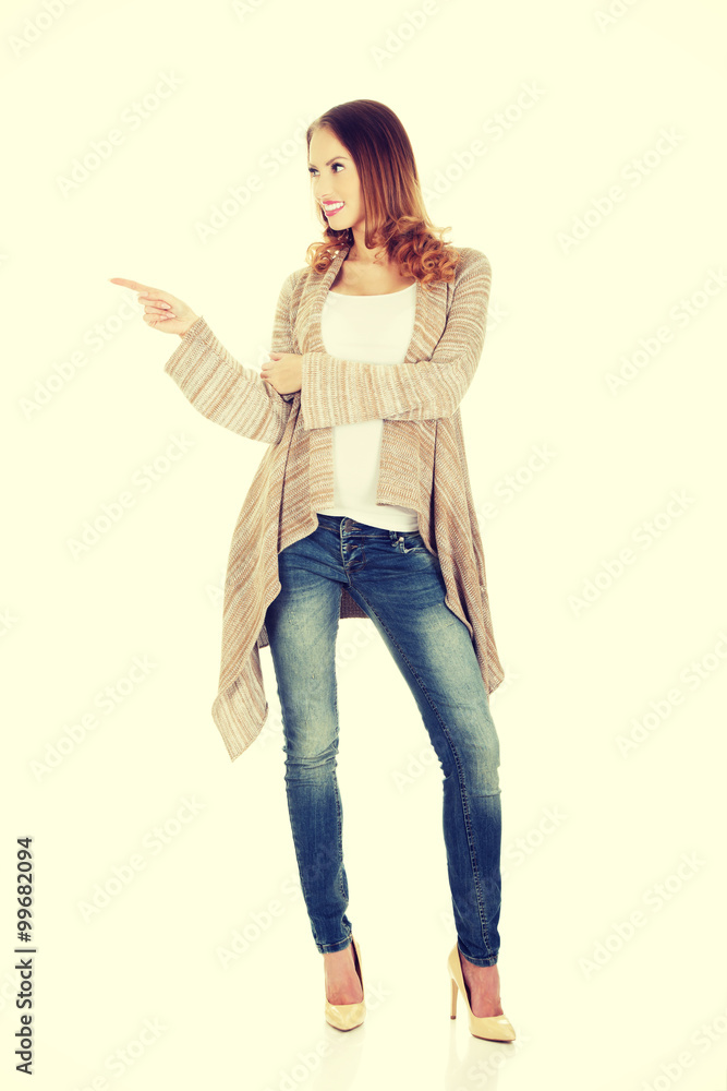 Happy smiling woman pointing aside. Happy smiling woman pointing aside.
