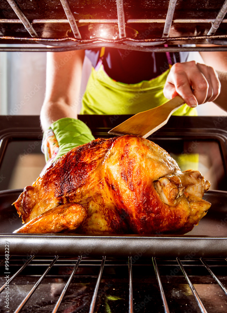 Naklejka premium Cooking chicken in the oven at home.