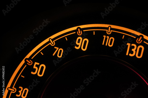speedometer at night inside a car
