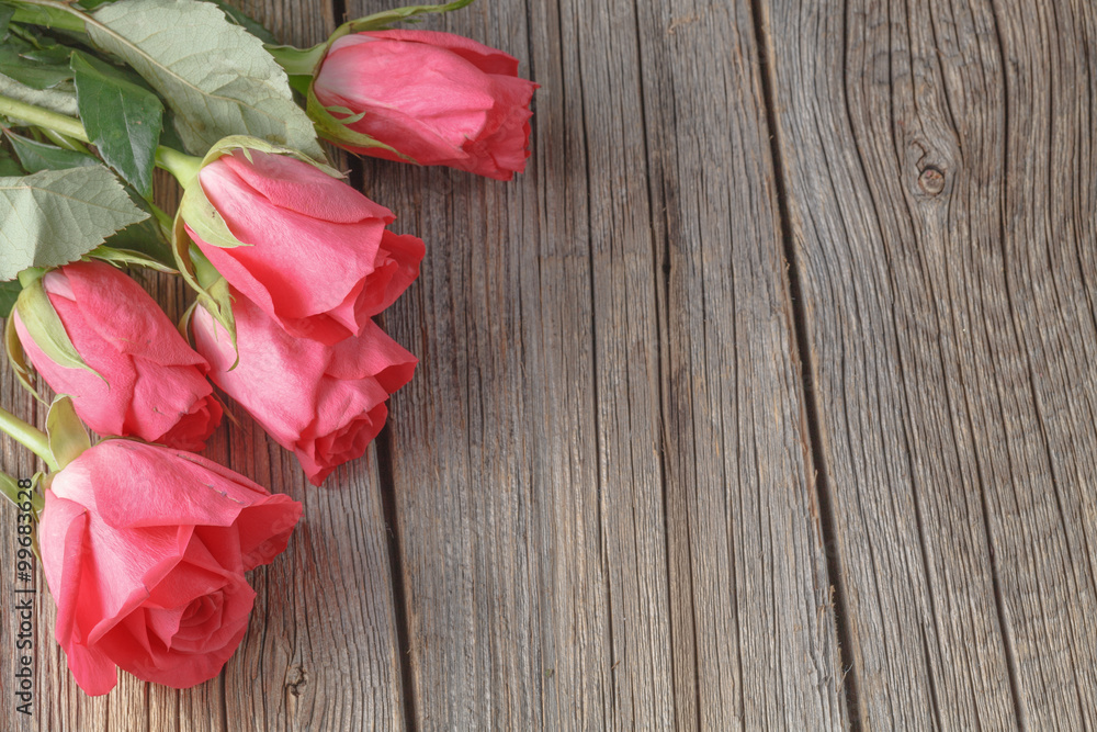Roses bouquet on old wooden table