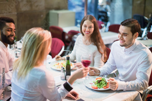 Portrait of relaxed adults having dinner outdoors © JackF