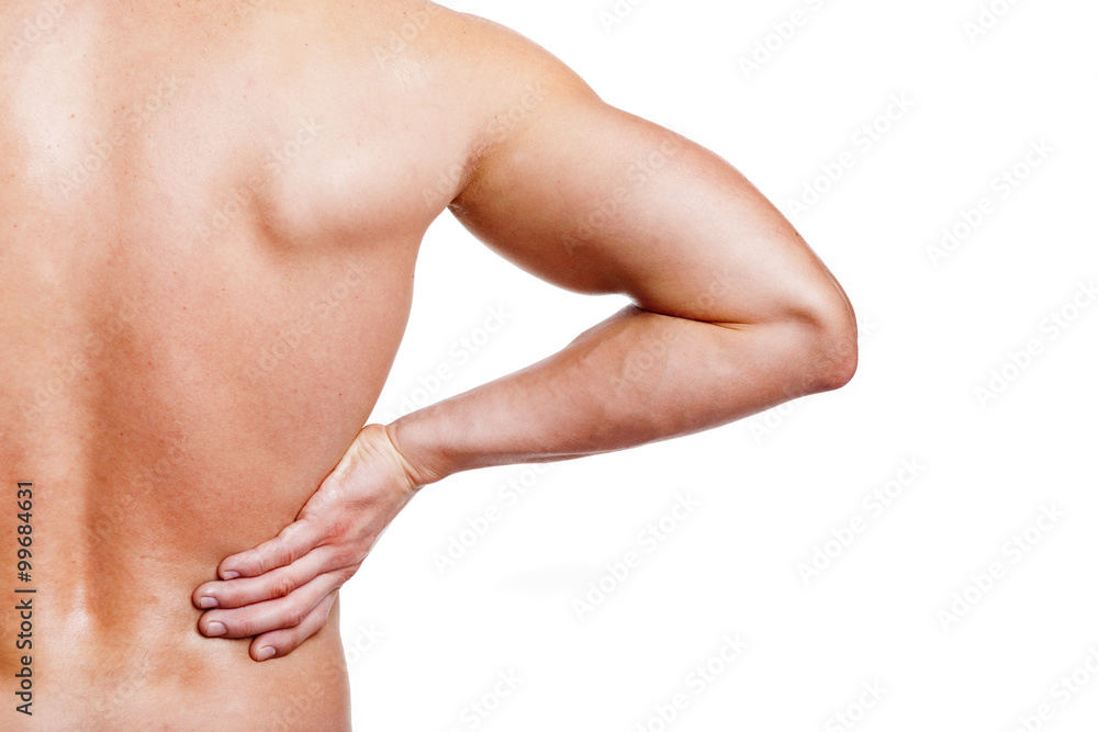 Muscular young man holding his back in pain, isolated on white b Muscular young man holding his back in pain, isolated on white b