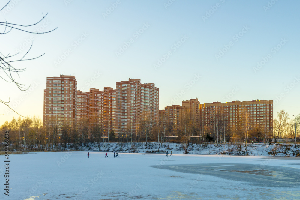 Fototapeta premium modern Russian city on the shore of a pond in winter 