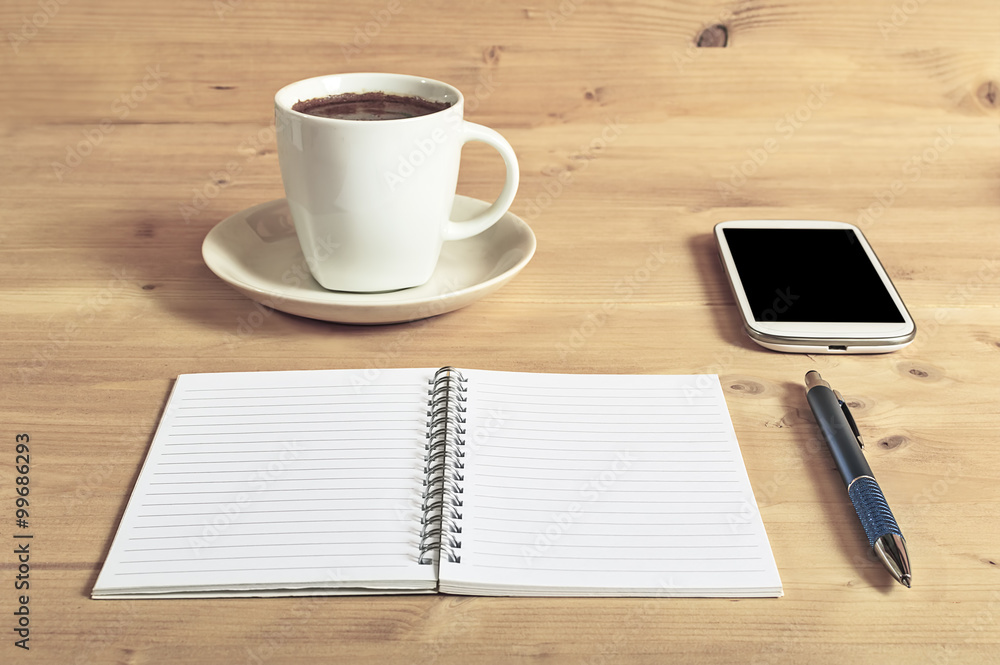 Still life photo of smartphone, notebook, coffee and pencil on w Still life photo of smartphone, notebook, coffee and pencil on w