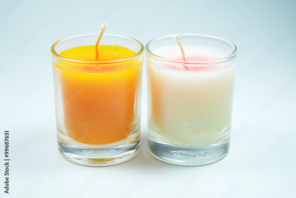 white and orange candles aroma in clear glass on white background white and orange candles aroma in clear glass on white background