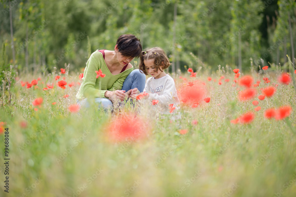 Mother with her little daughter in poppy field Mother with her little daughter in poppy field