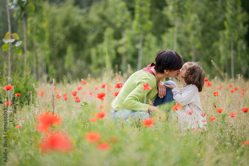 Mother with her little daughter in poppy field Mother with her little daughter in poppy field