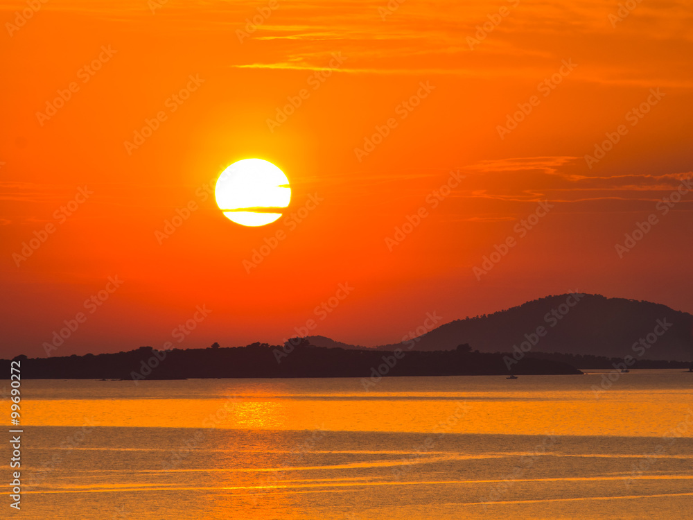 Sunset at sea, with small greek islands in background