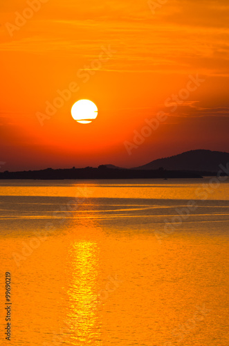 Sunset at sea  with small greek islands in background