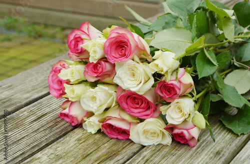 pink and white  roses on the wooden table.  pink and white flower for a special day