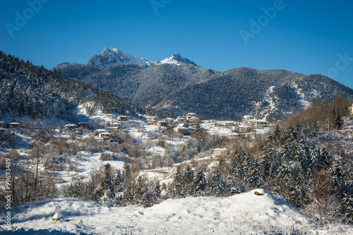 Scenic landscape with mountains covered with snow at lake Plasti photo