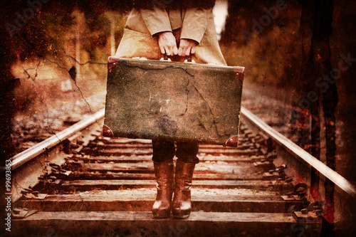 Elegant woman with a suitcase traveling by rail.