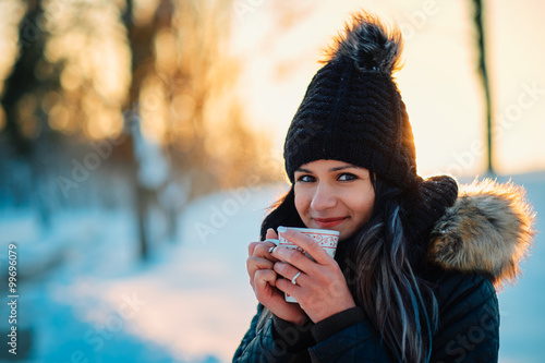 Young woman drinking hot tea winter snow outdoor © Creaturart