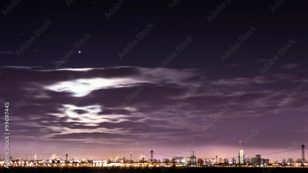 city celebrating New Year's Eve with flashing fireworks. Night sky with clouds and moon
city celebrating New Year's Eve with flashing fireworks. Night sky with clouds and moon