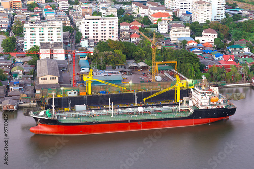 Top view cargo ship on Chao Phraya river and city scape in Bangk