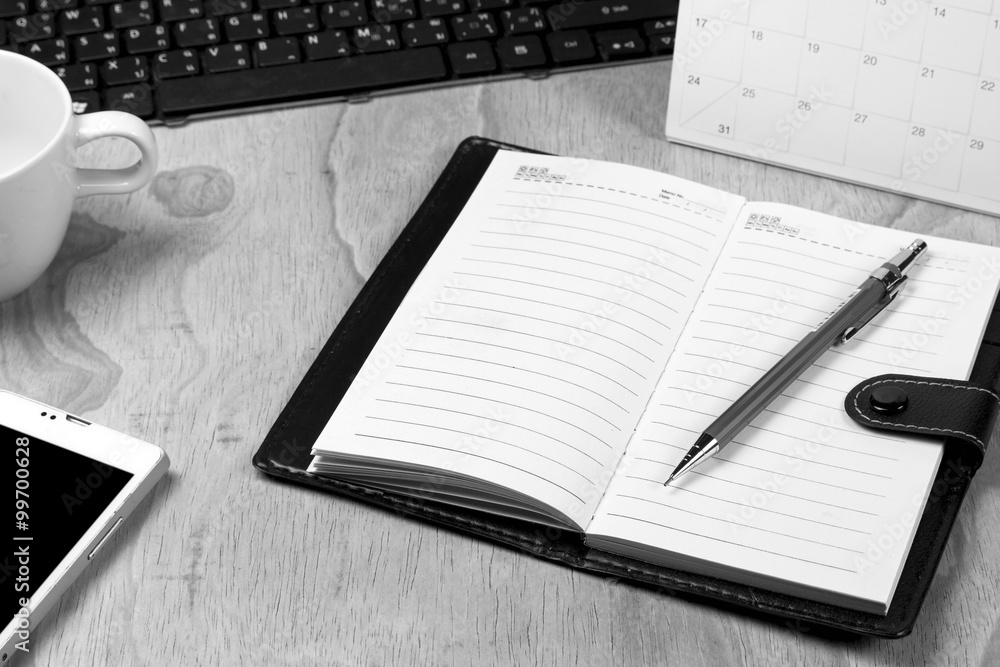 notebook on office desk,black and white, selective focused notebook on office desk,black and white, selective focused