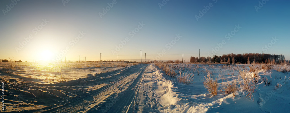 Sunset sky under the snowy field panoramic photo