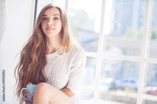 Beautiful lady sitting by the window indoor Free Download Beautiful lady sitting by the window indoor - GFXLoad