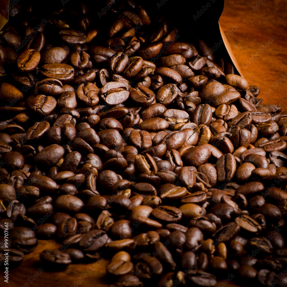 Fototapeta premium spilled coffee, coffee beans out of the box
