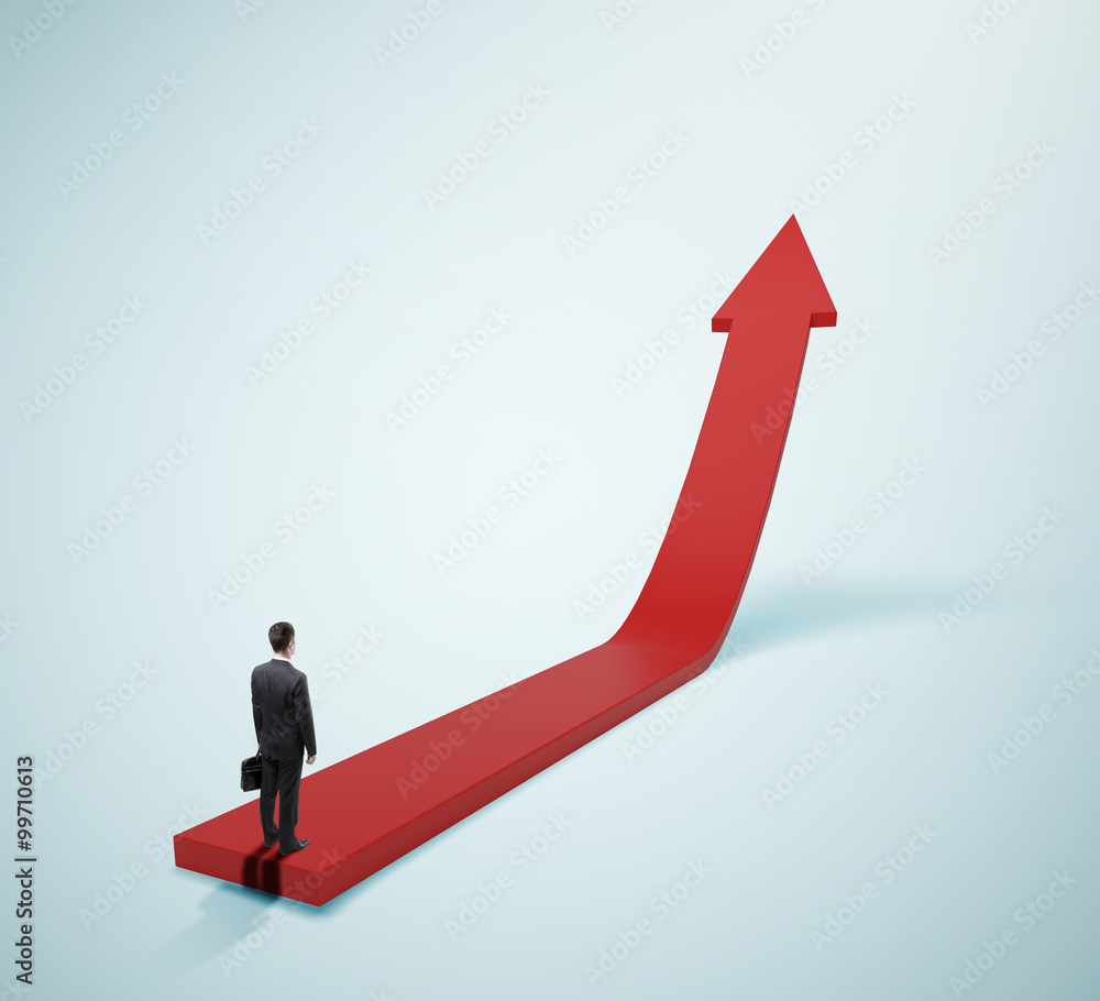 businessman standing on red arrow businessman standing on red arrow