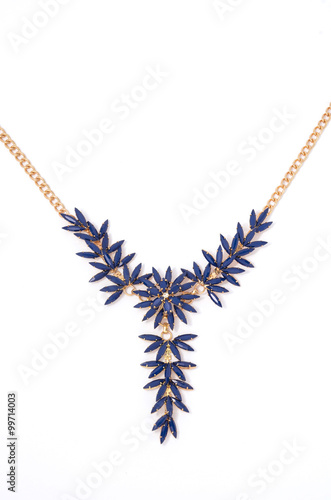gold necklace with blue flowers on a white background close-up