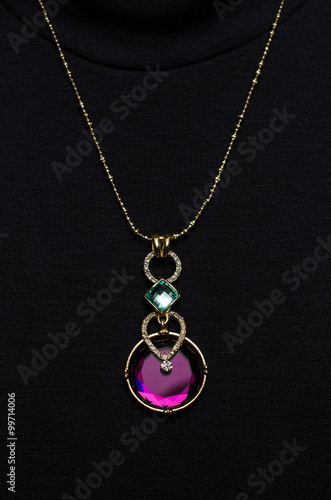 Pendant with sapphire on a black background