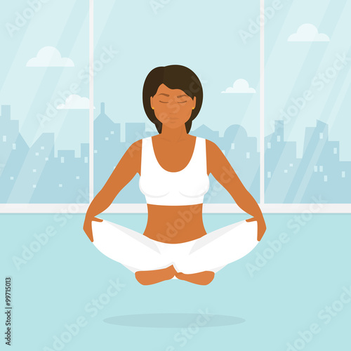 Woman is doing yoga and sitting in the lotus position