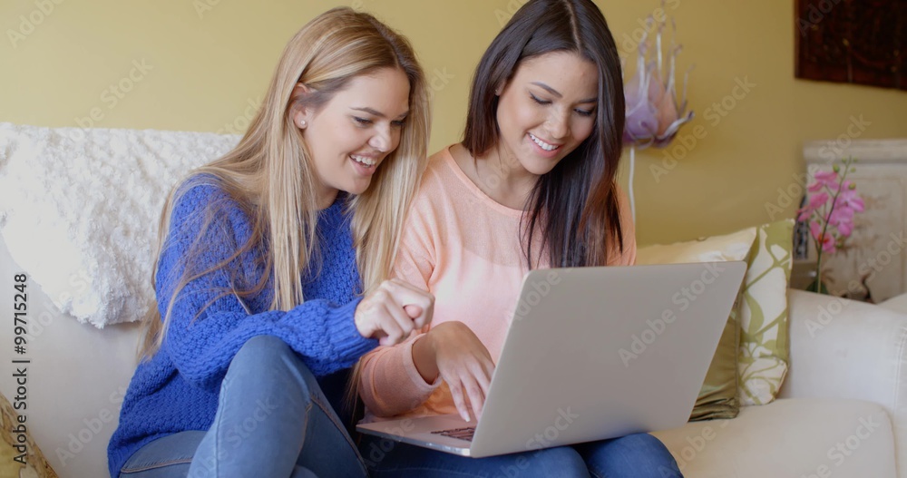 Two happy young women browsing the internet Two happy young women browsing the internet