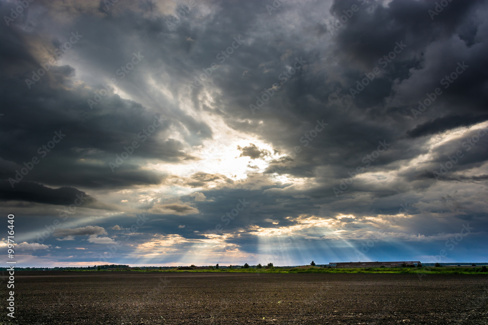 The rays of the sun bursting from the clouds. The rays of the sun bursting from the clouds.