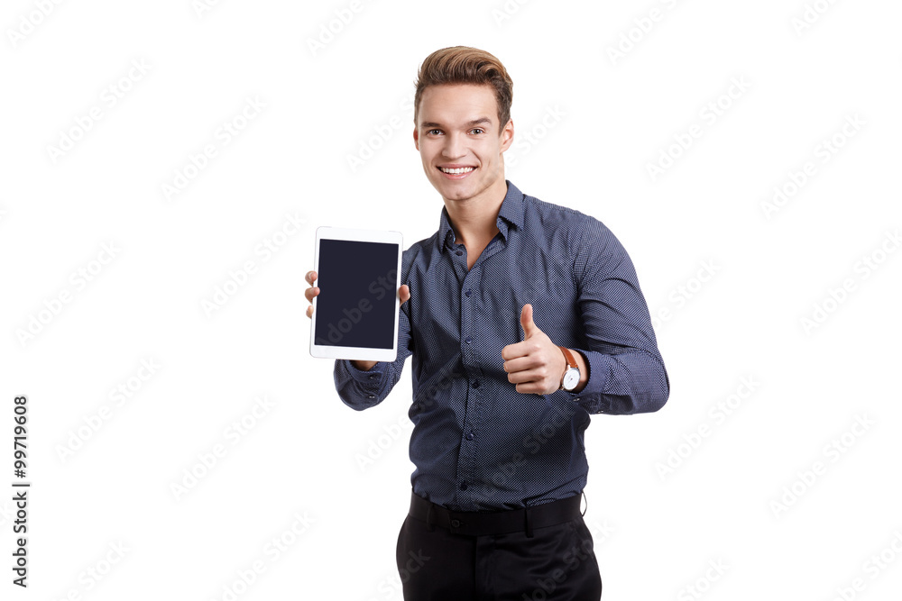Young man Looking at a tablet, isolated in white Young man Looking at a tablet, isolated in white