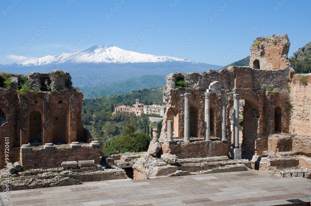 Obraz premium Ruins of the Greek Roman Theater in Taormina and volcano Etna, Sicily, Italy